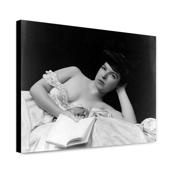 Canvas Print: Young Woman, Wearing Negligee, Lying In Bed, Holding Book, circa