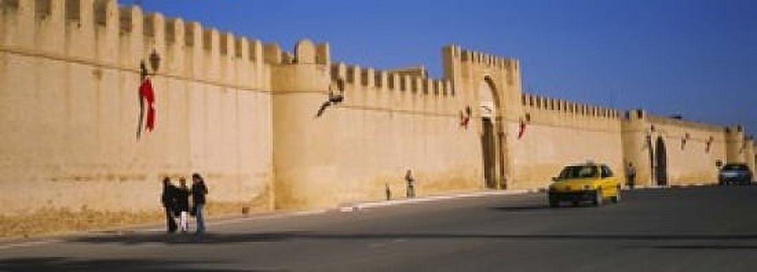 Car on a road in front of a fortified wall Medina Kairwan Tunisia Canvas Art - Panoramic Images (18 x 7)