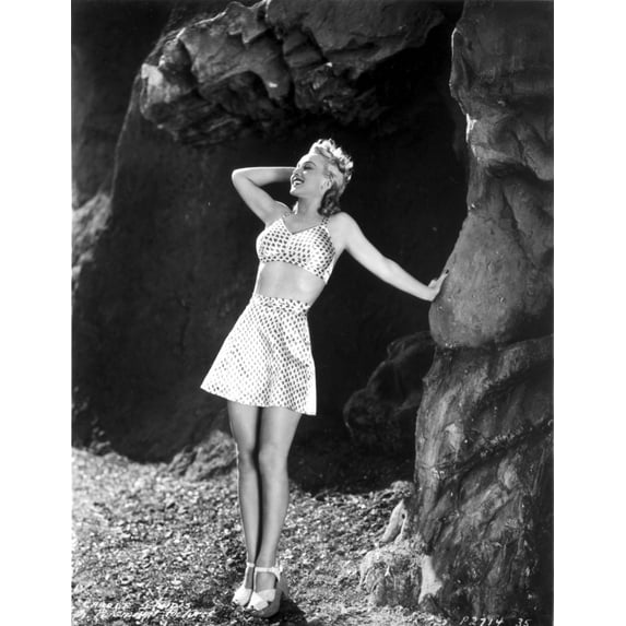Carole Landis in Printed Bra and Skirt, Hand Leaning on Rock Photo Print (24 x 30)