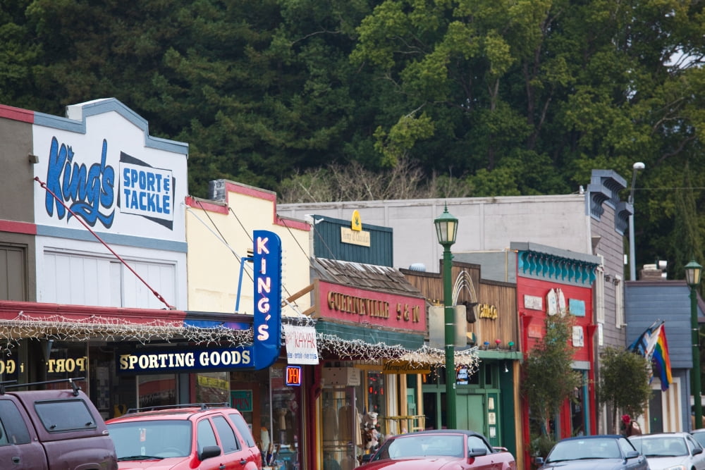 Cars parked outside stores in a city Guerneville Russian River Valley Sonoma County California USA Canvas Art - Panoramic Images (27 x 9)