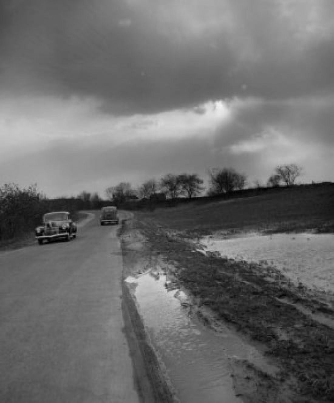 Cars passing each other under cloudy skies Canvas Art - (18 x 24)