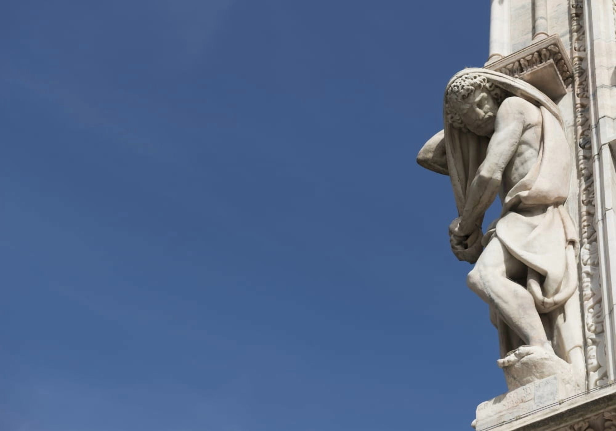 Carved sculpture of male likeness on the facade of Milan Cathedral against a blue sky Milan Lombardy Italy Canvas Art - Mats Silvan Design Pics (18 x 12)