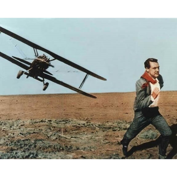 Cary Grant runs from crop duster biplane in desert North by Northwest 8x10 photo