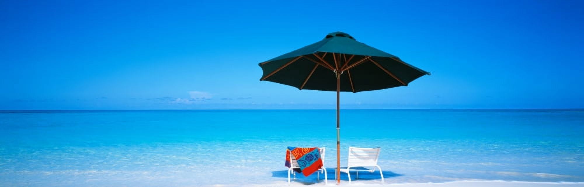 Chairs Under An Umbrella On The Beach Turks And Caicos Islands North Atlantic Ocean Canvas Art - Panoramic Images (27 x 9)