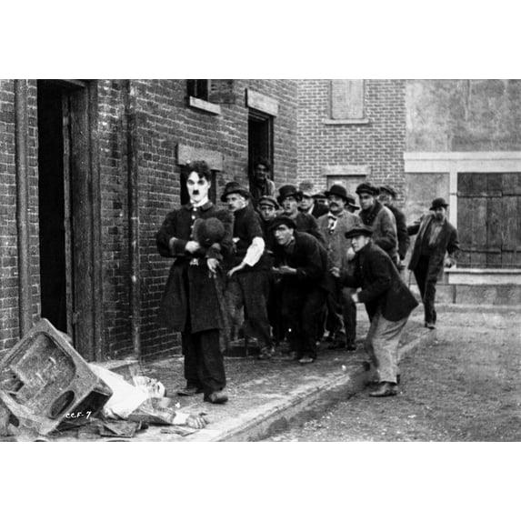 Charlie Chaplin Walking on Street with Men Following Him Photo Print (24 x 30)