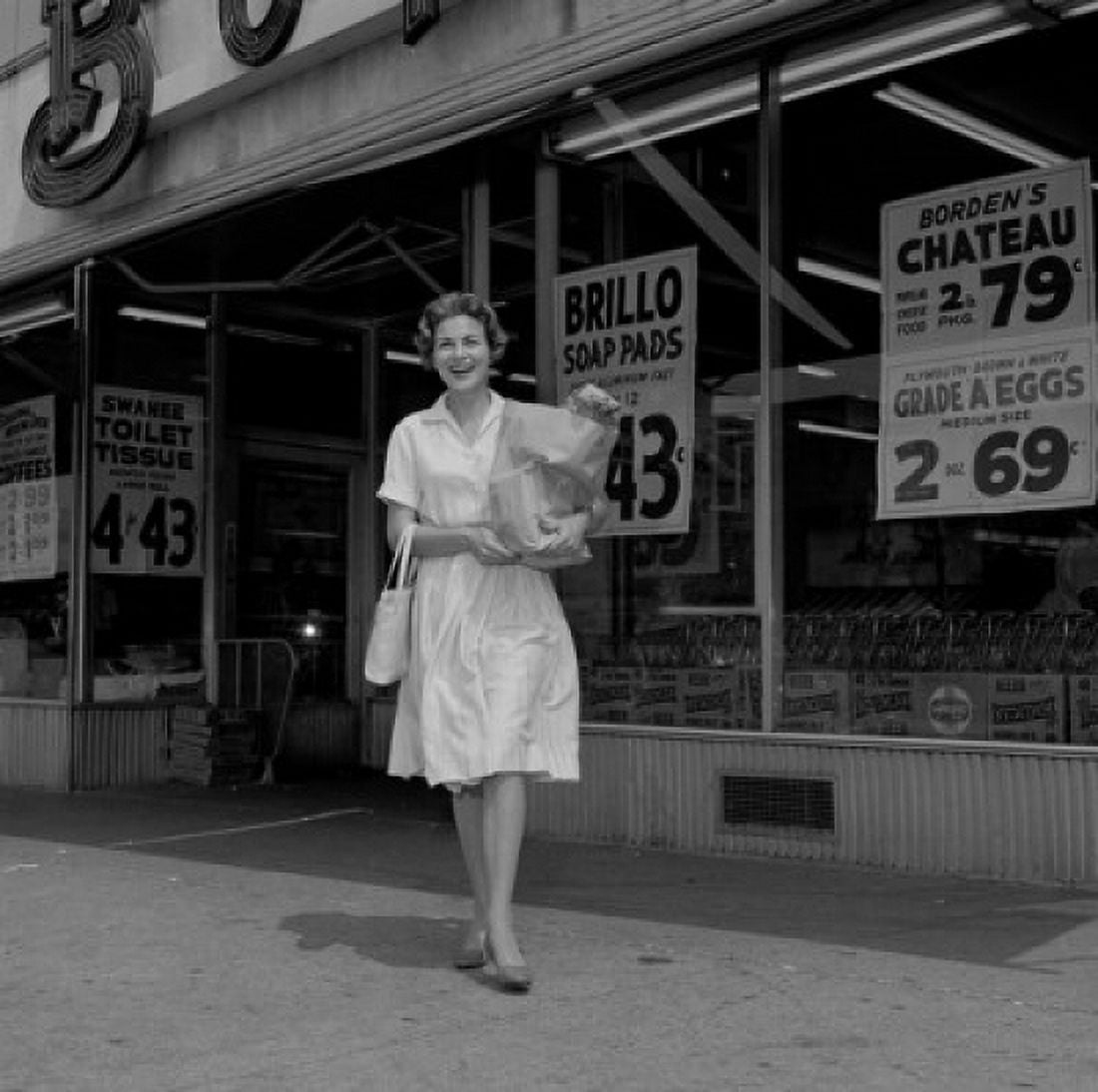 Cheerful housewife outside supermarket carrying shopping bag Canvas Art - (18 x 24)