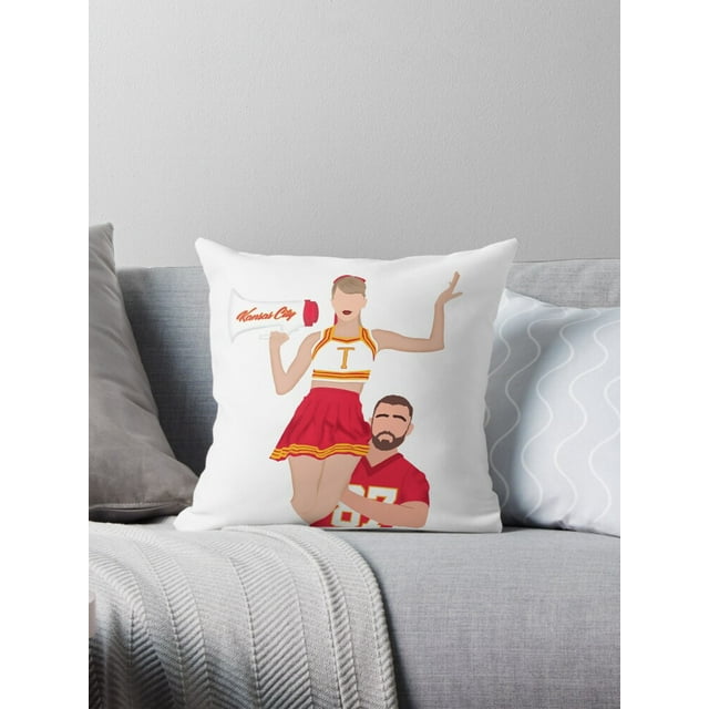 Cheerleader sitting on football player’s shoulder. Wearing red and