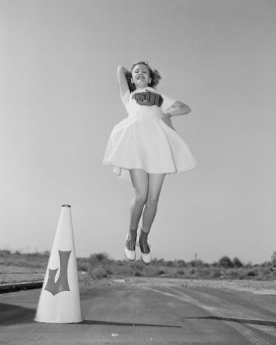 Cheerleader with megaphone jumping Canvas Art - (24 x 36)
