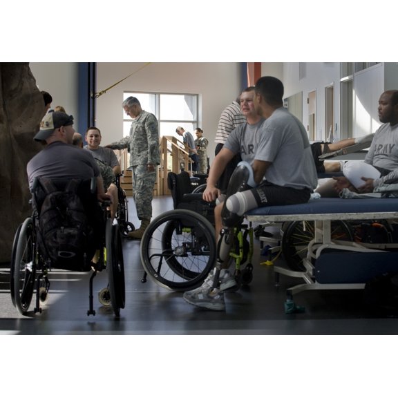 Chief Of Staff Of The Army General George W. Casey Center Left Talks With A Wheel Chair Bound Soldier While Other Wounded Do Their Physical Therapy At The Center For The Intrepid Fort Sam Houston