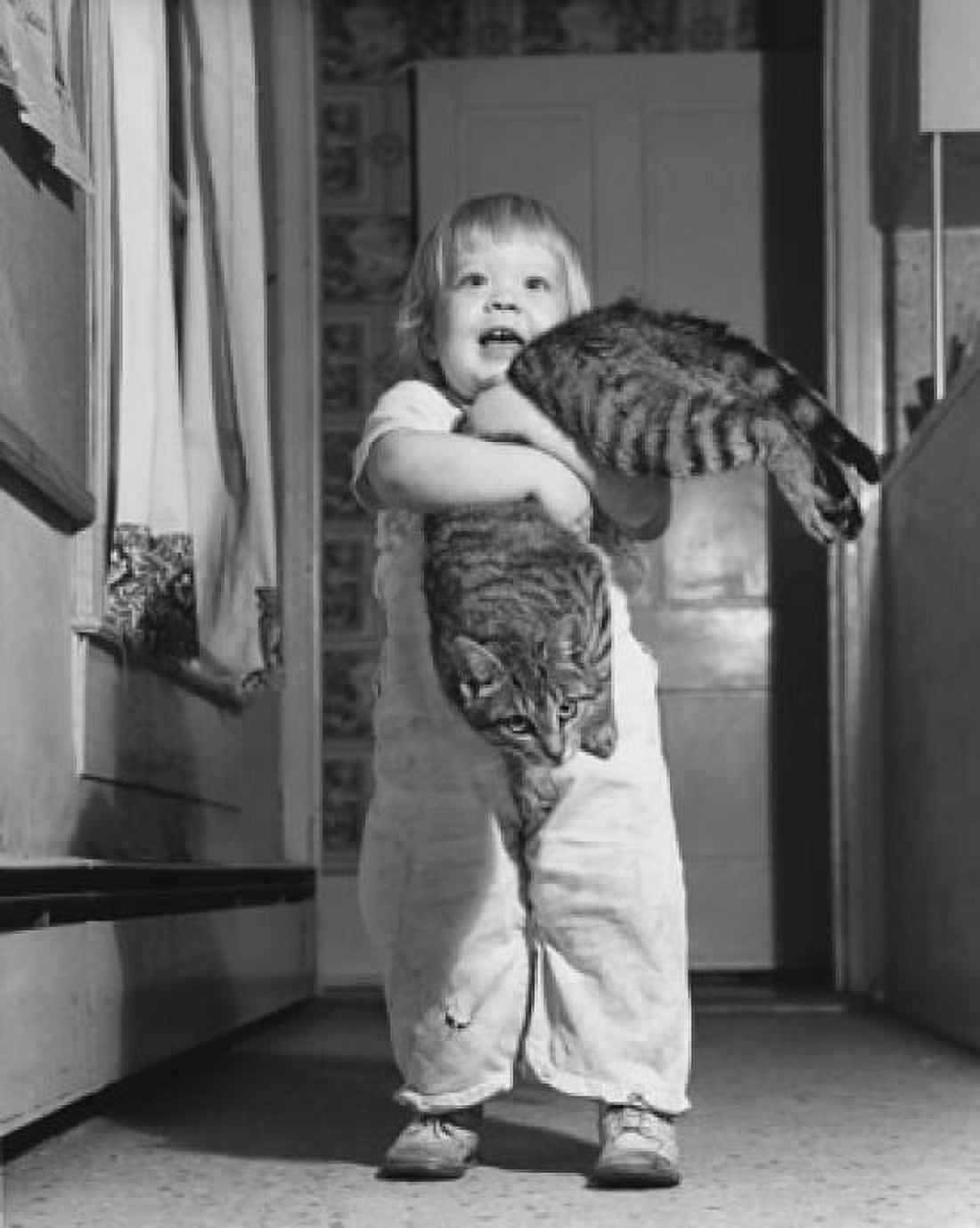Child holding cat in house Canvas Art - (24 x 36)