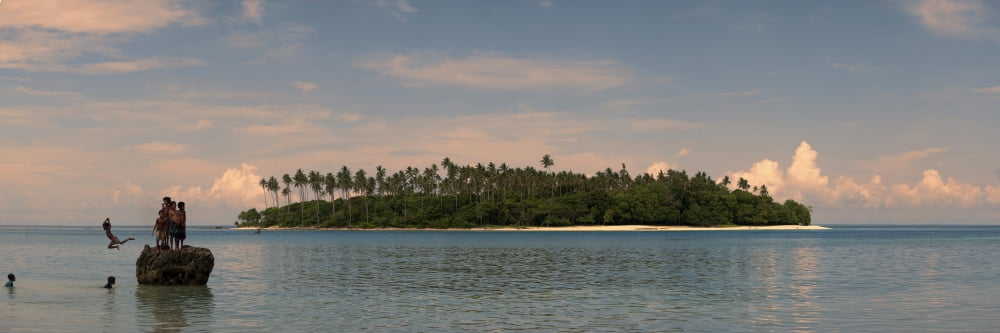 Children jumping in the ocean from a rock Papua New Guinea Canvas Art - Panoramic Images (36 x 12)
