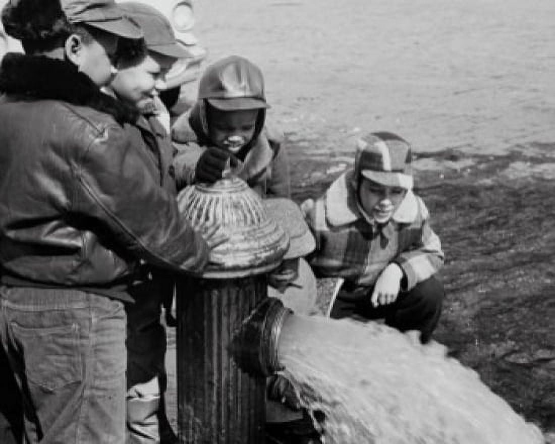 Children looking at an open fire hydrant Canvas Art - (24 x 36)