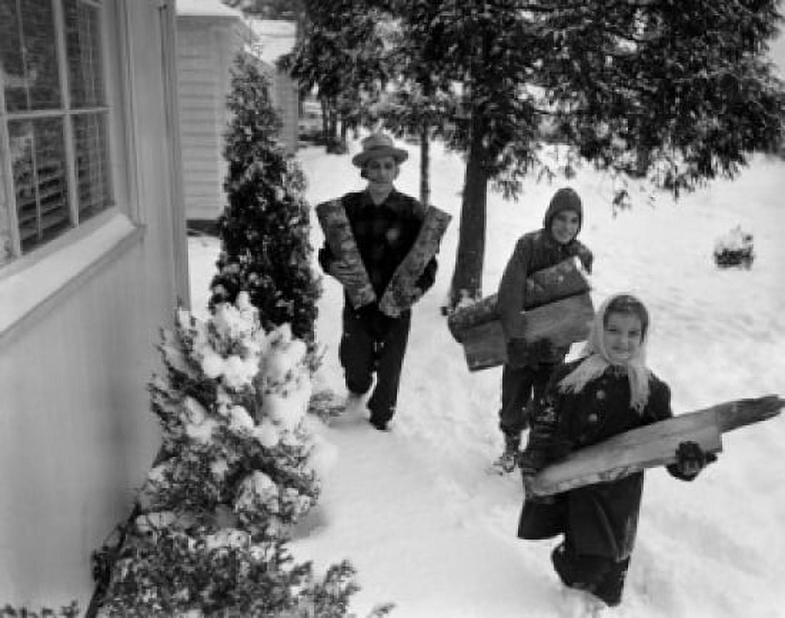 Children with father carrying wood logs in winter Canvas Art - (24 x 36)