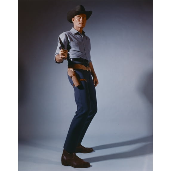 Chuck Connors standing in Cowboy Outfit with Pistol Photo Print (24 x 30)