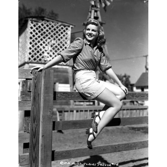 Claire Trevor sitting on Wood Fence with Heels Photo Print (24 x 30)