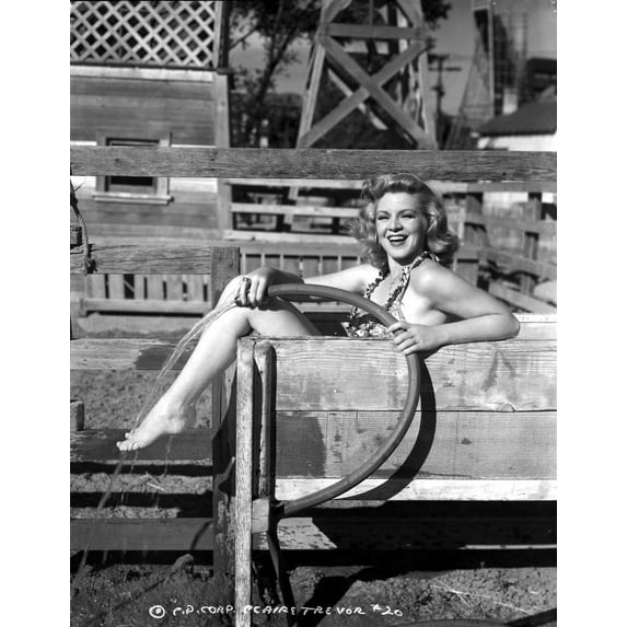 Claire Trevor smiling in Lingerie while Holding Water Hose Photo Print (8 x 10)