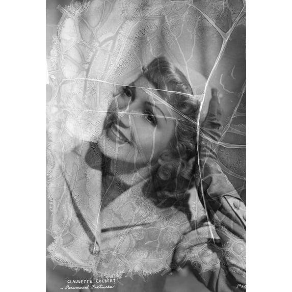 Claudette Colbert Looking up in Coat with Head Leaning on Hand Photo Print (8 x 10)