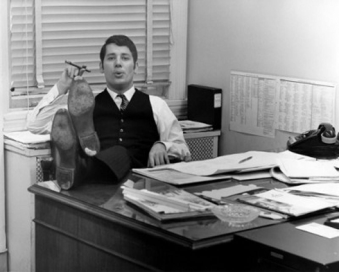 Clerk sitting in office room with legs on table smoking cigar Canvas Art - (18 x 24)