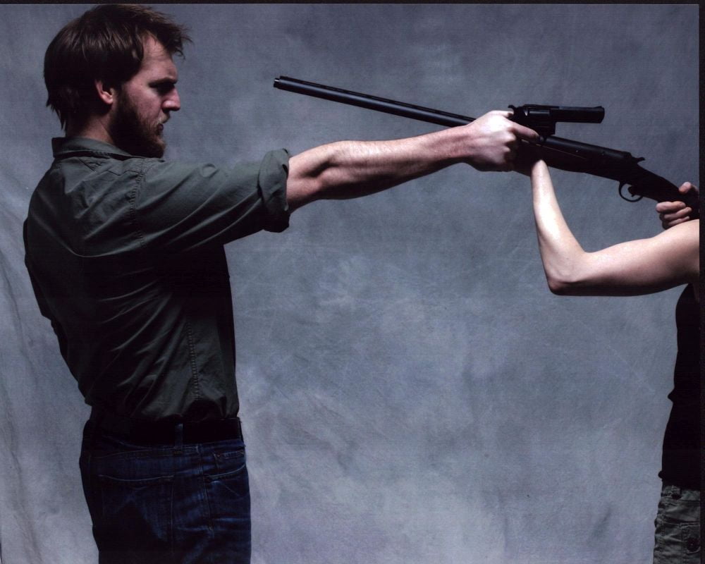 Cliff Chamberlain Pointing Gun At Off Camera Woman Holding Shotgun Photo Print (8 x 10) Item