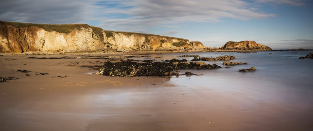 Cliffs in the sunlight along the coastSouth shields tyne and wear england Canvas Art - John Short Design Pics (33 x 13)