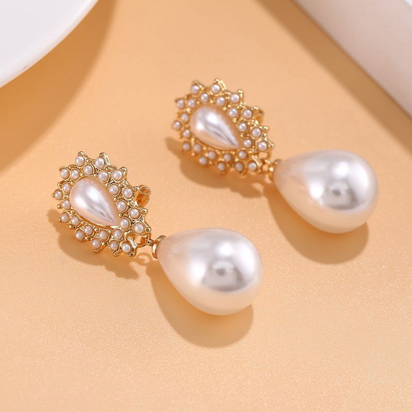 Clip on gold dangle teardrop pearl earrings