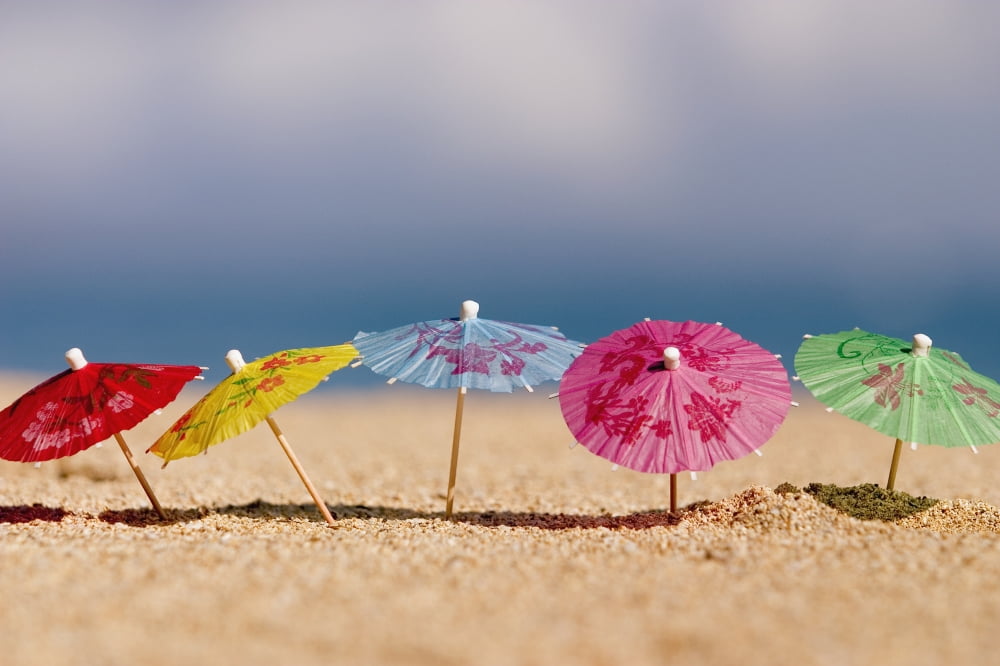 Close-Up Of Cocktail Umbrellas In The Sand Canvas Art - Ron Dahlquist Design Pics (18 x 12)