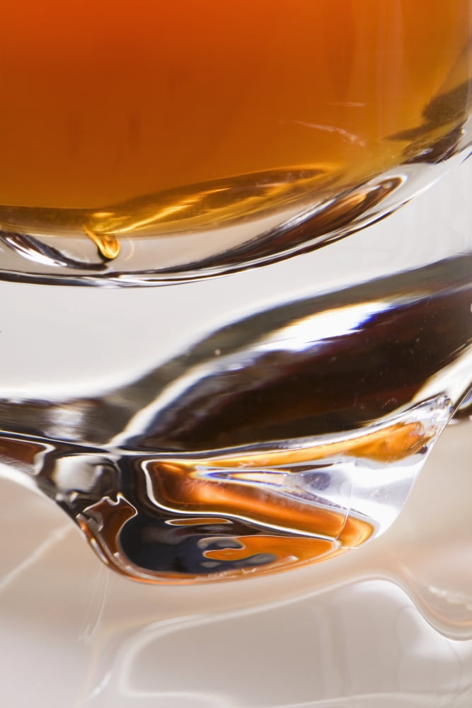 Close-Up Of The Base Of A Glass Filled With An Orange Liquid Canvas Art - Michael Interisano Design Pics (24 x 38)