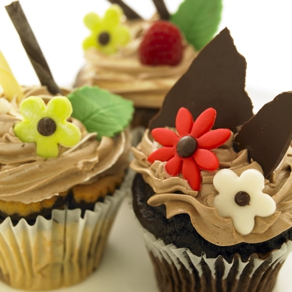 Close-Up Of Three Chocolate Cupcakes With Candy Flowers. Poster Print
