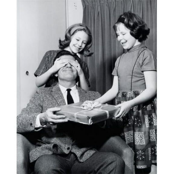 Close-Up of Two Daughters Giving a Surprise Gift to Their Father Poster Print - 18 x 24 in.