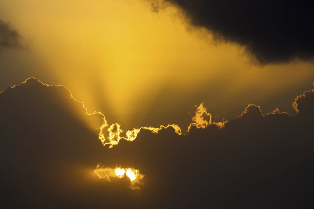 Close up of the sun coming through clouds with rays beaming up at sunrise Akumal Quintana Roo Mexico Canvas Art - Michael Interisano Design Pics (38 x 24)