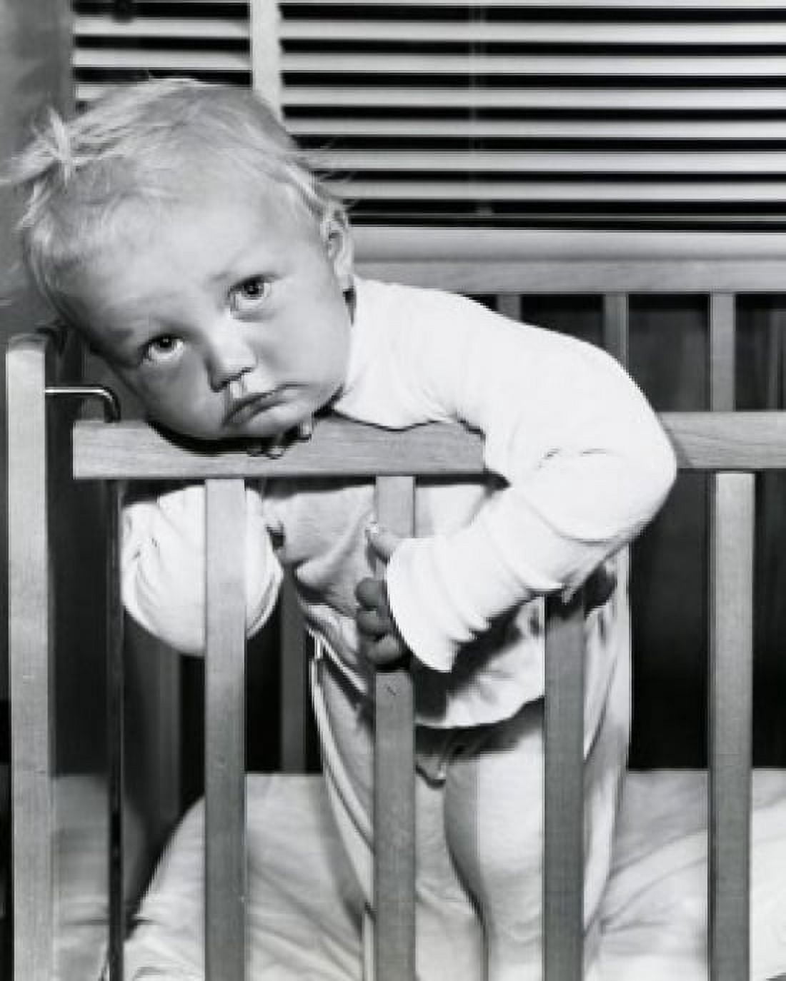 Close-up of a baby boy leaning over a crib Canvas Art - (24 x 36)