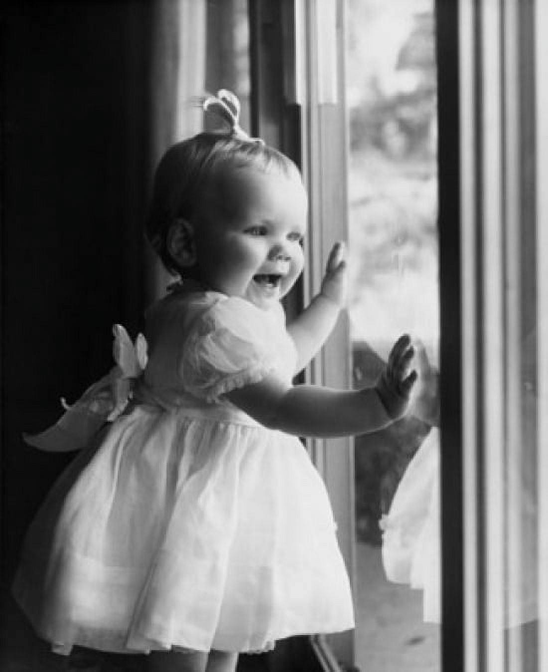 Close-up of a baby girl standing near a window Canvas Art - (18 x 24)
