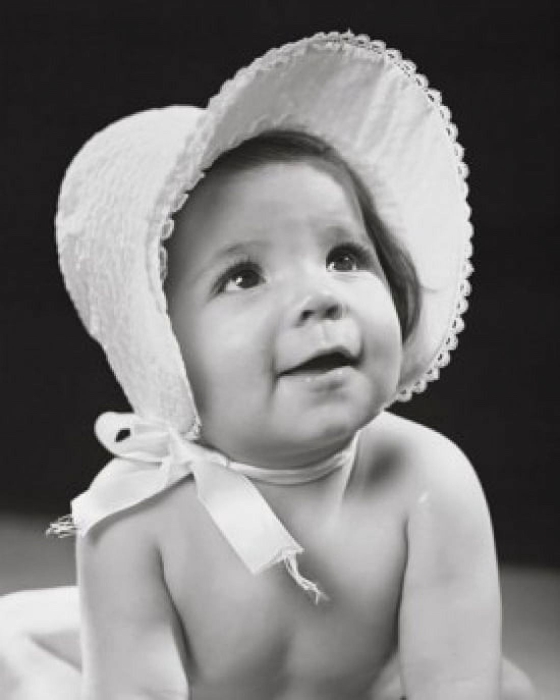 Close-up of a baby girl wearing a bonnet and smiling Canvas Art - (24 x 36)
