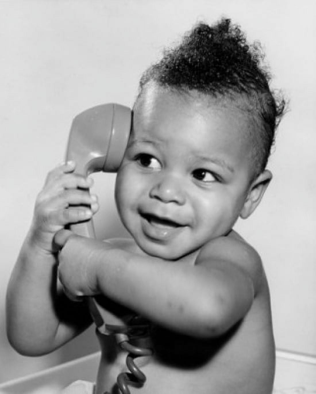 Close-up of a baby holding a telephone receiver Canvas Art - (24 x 36)