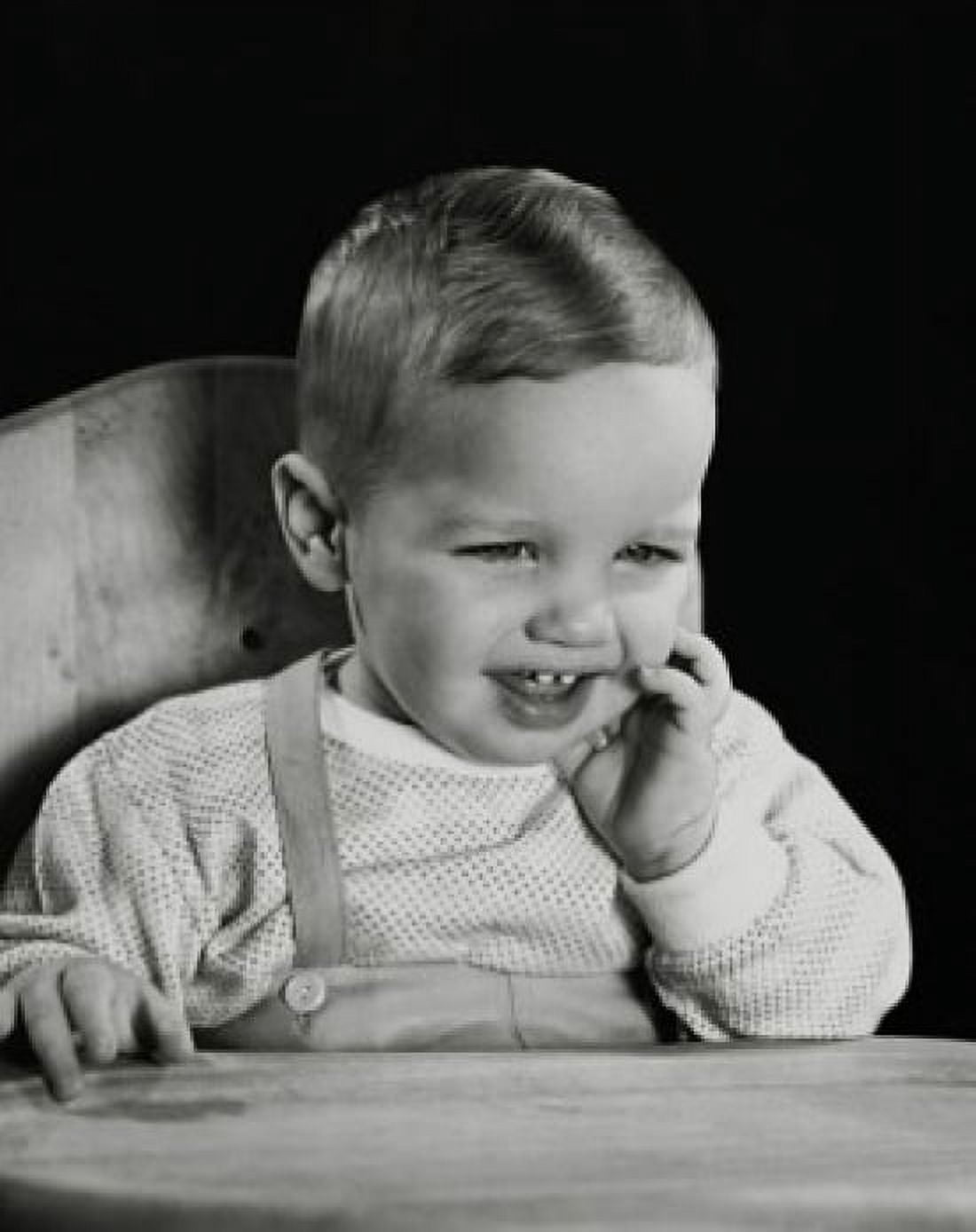 Close-up of a baby sitting in a high chair and smiling Canvas Art - (18 x 24)