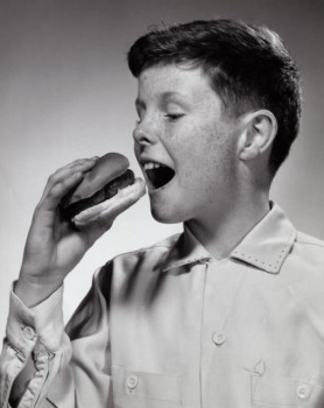 Close-up of a boy eating a burger Canvas Art - (24 x 36)