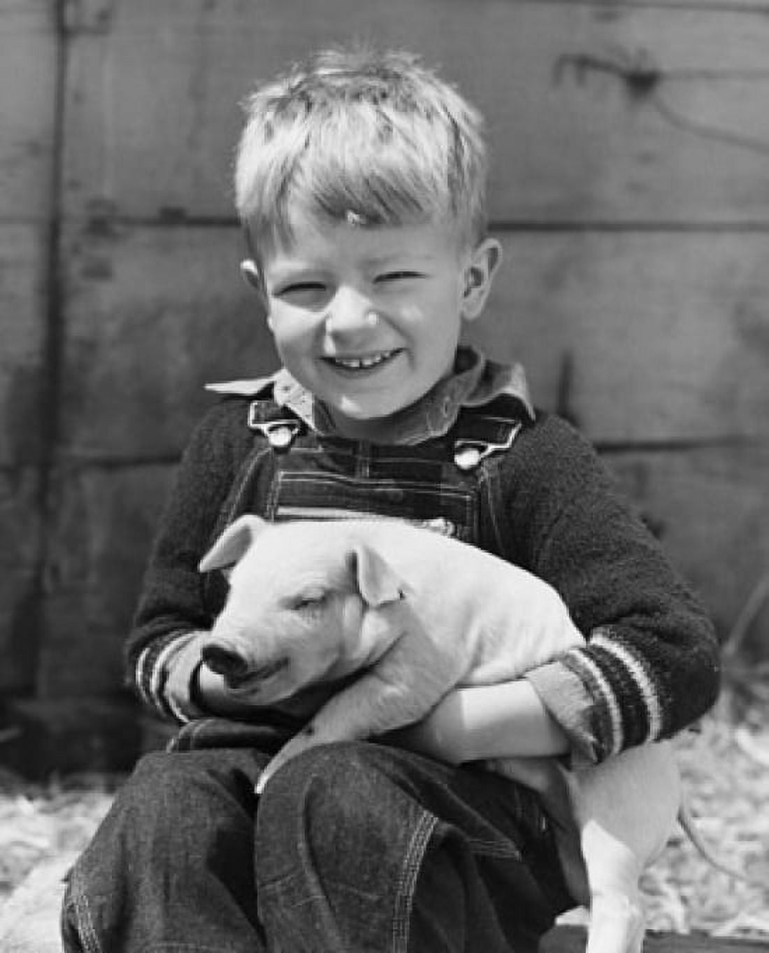 Close-up of a boy holding a piglet and smiling Canvas Art - (18 x 24)