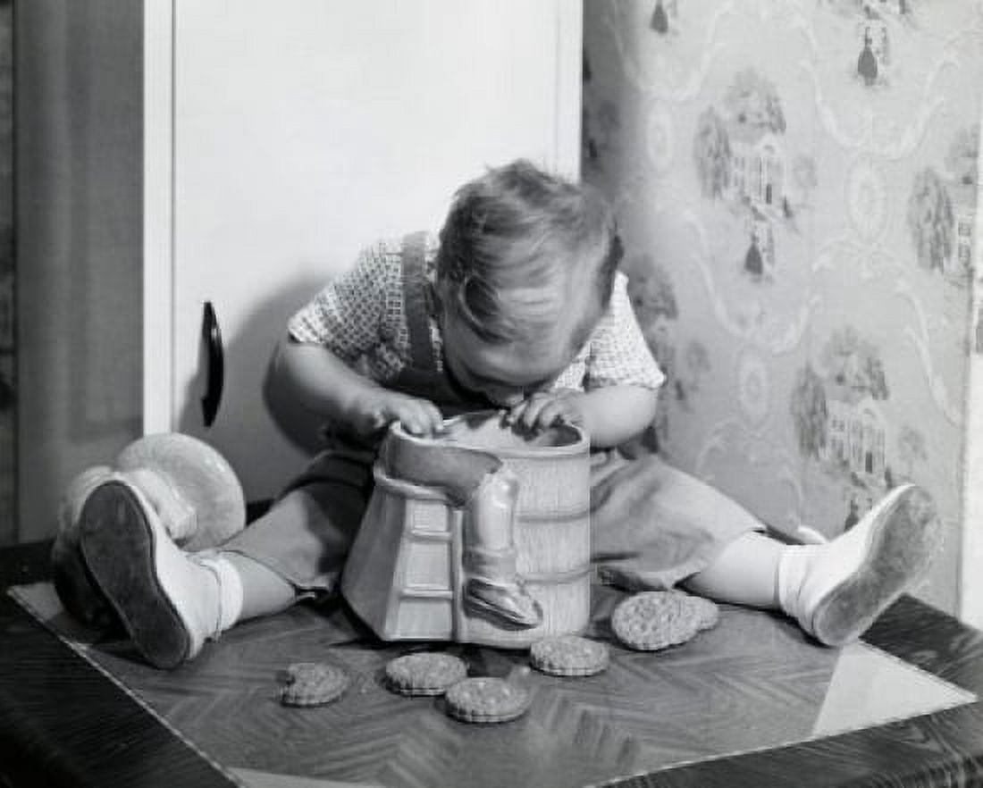 Close-up of a boy looking into a cookie jar Canvas Art - (18 x 24)