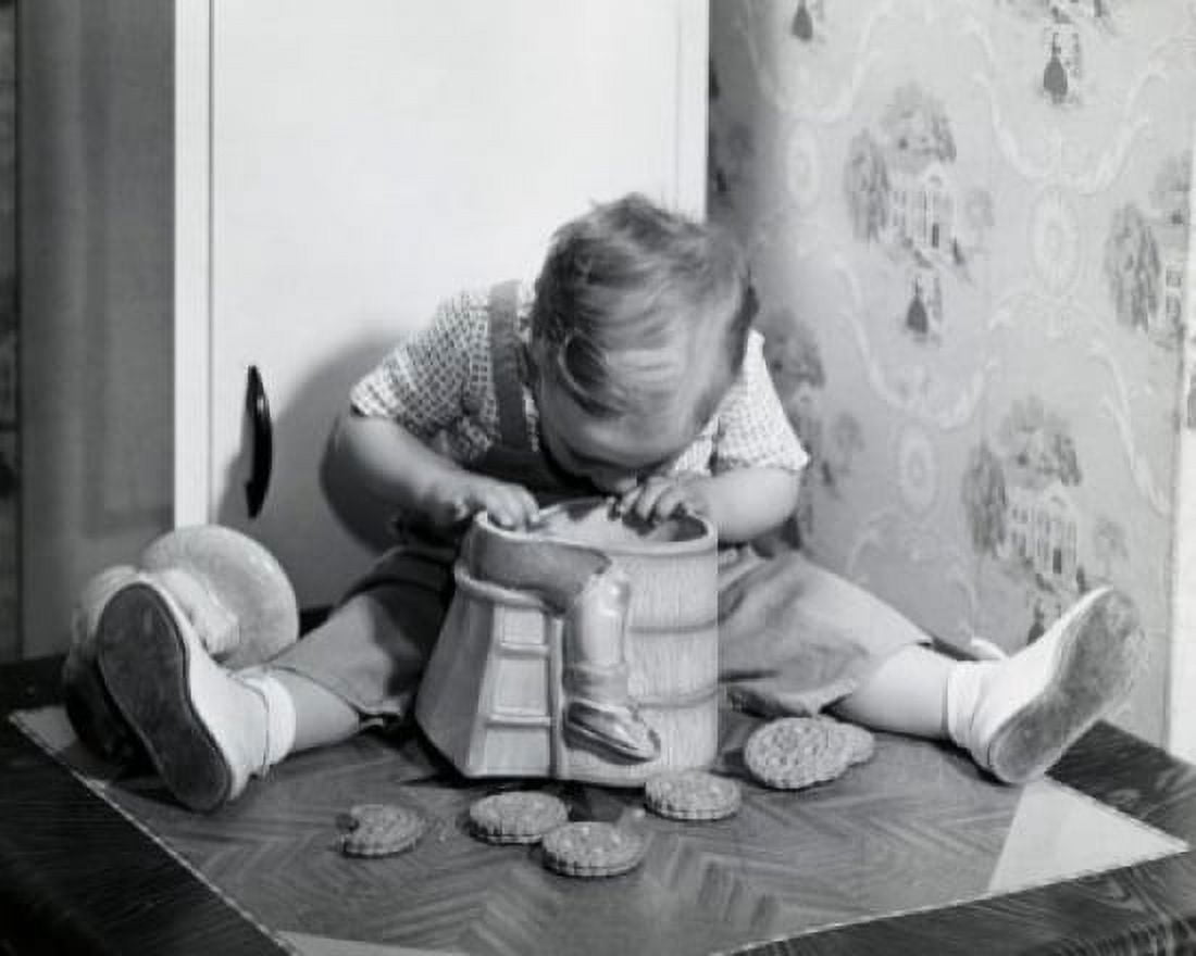 Close-up of a boy looking into a cookie jar Canvas Art - (24 x 36)