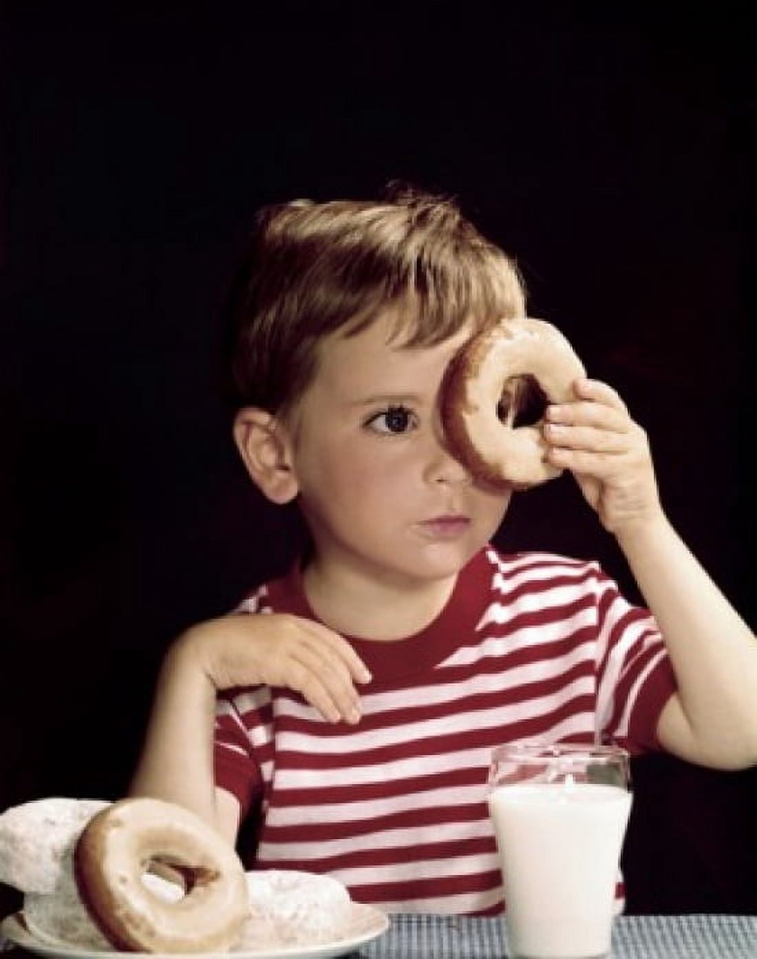 Close-up of a boy looking through a donut Canvas Art - (18 x 24)