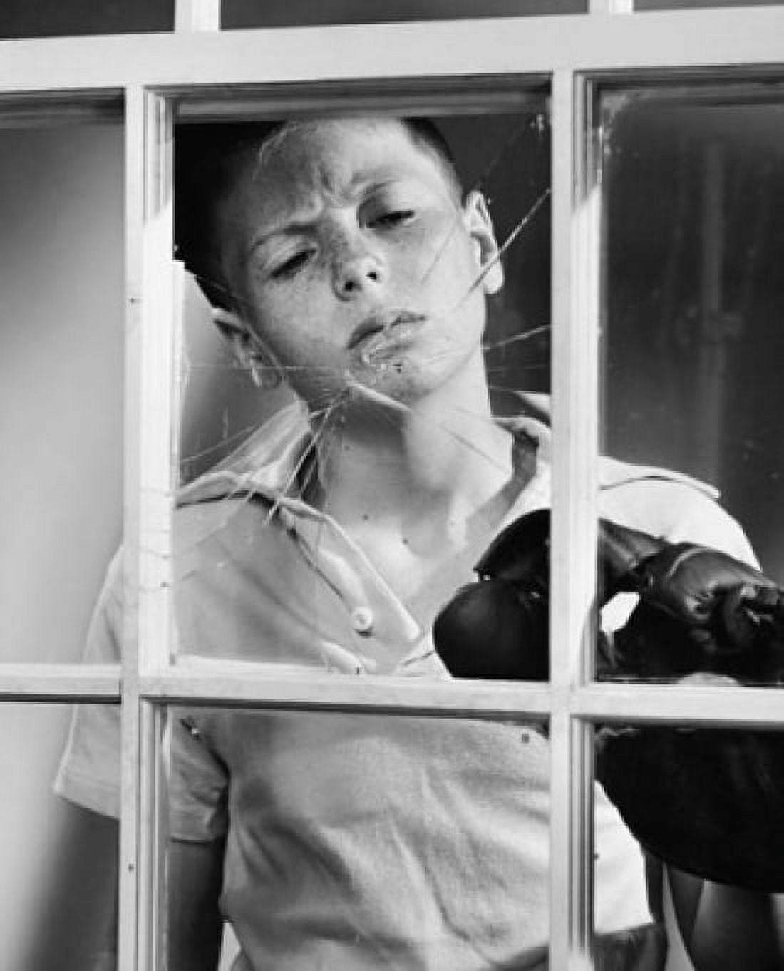 Close-up of a boy wearing a baseball glove and looking at a broken window Canvas Art - (18 x 24)