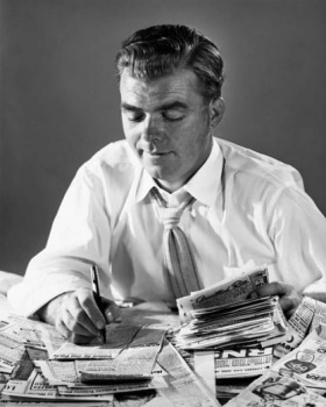 Close-up of a businessman writing on newspaper cuttings Canvas Art - (18 x 24)