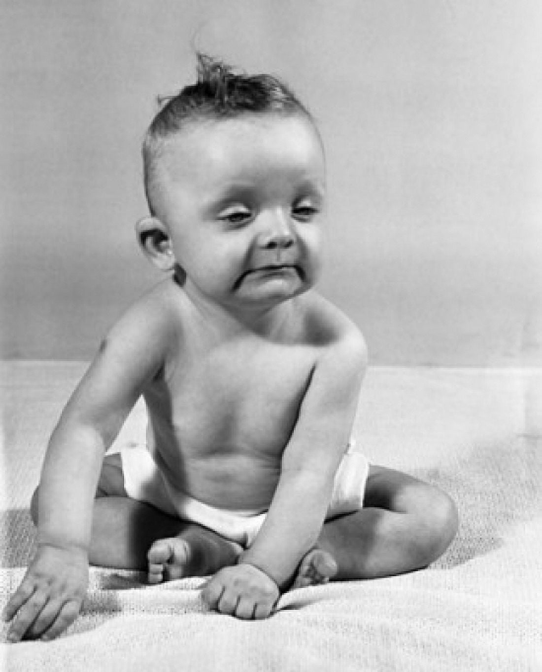 Close-up of a crying baby sitting on a bed Canvas Art - (24 x 36)