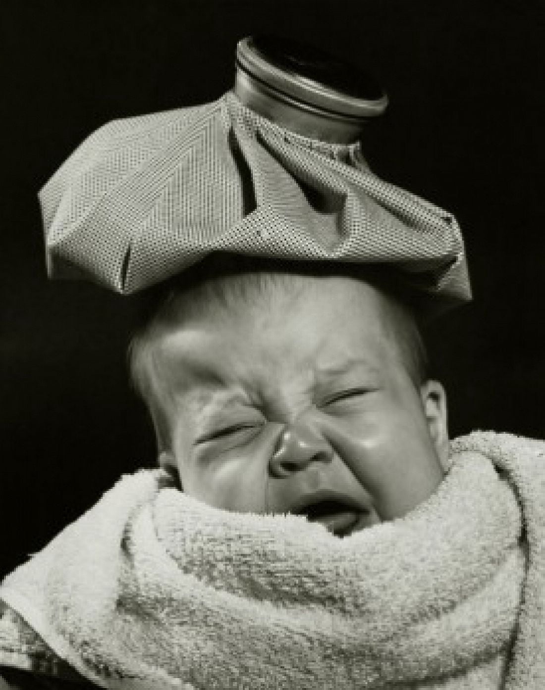 Close-up of a crying baby with an ice pack on his head Canvas Art - (24 x 36)