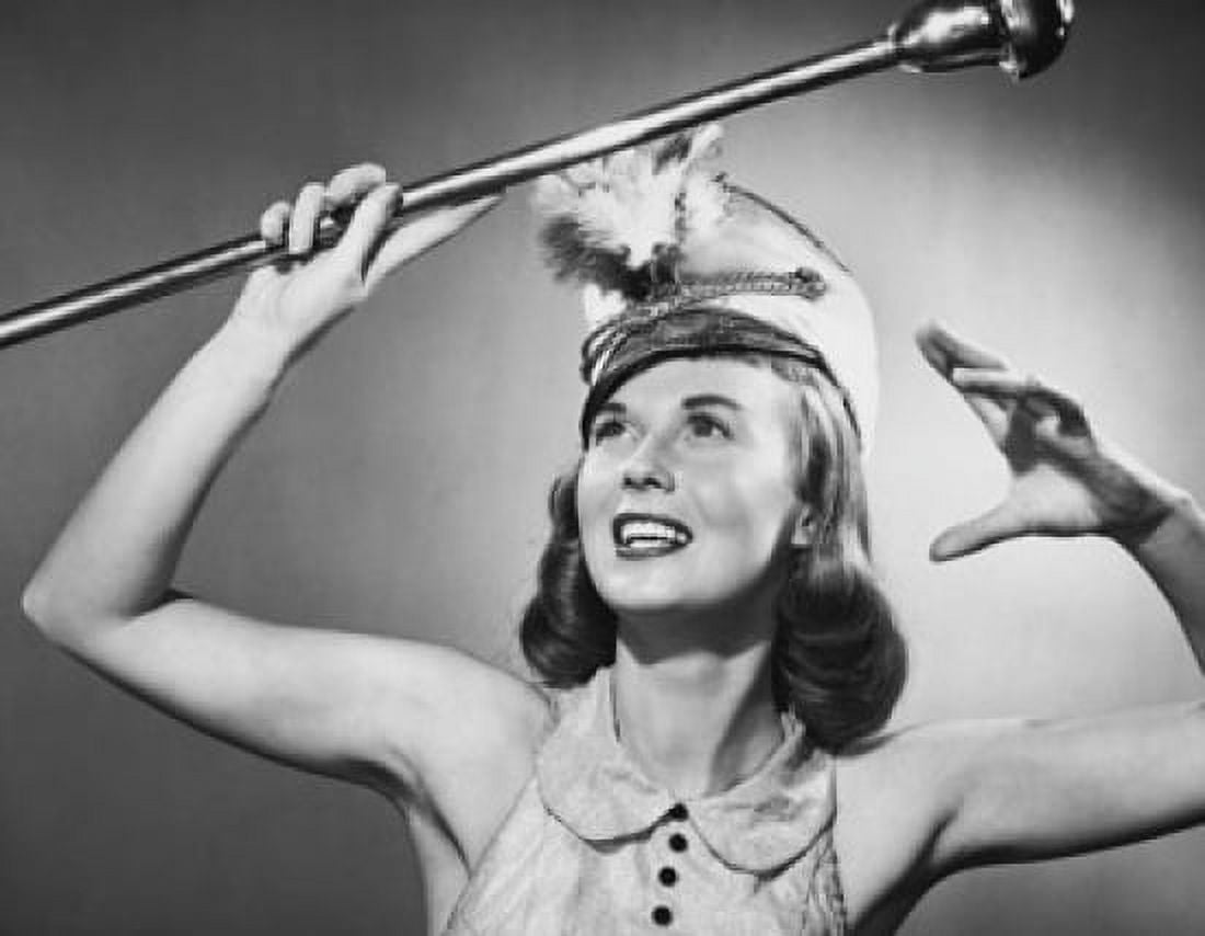 Close-up of a drum majorette performing with a twirling baton and smiling Canvas Art - (24 x 36)