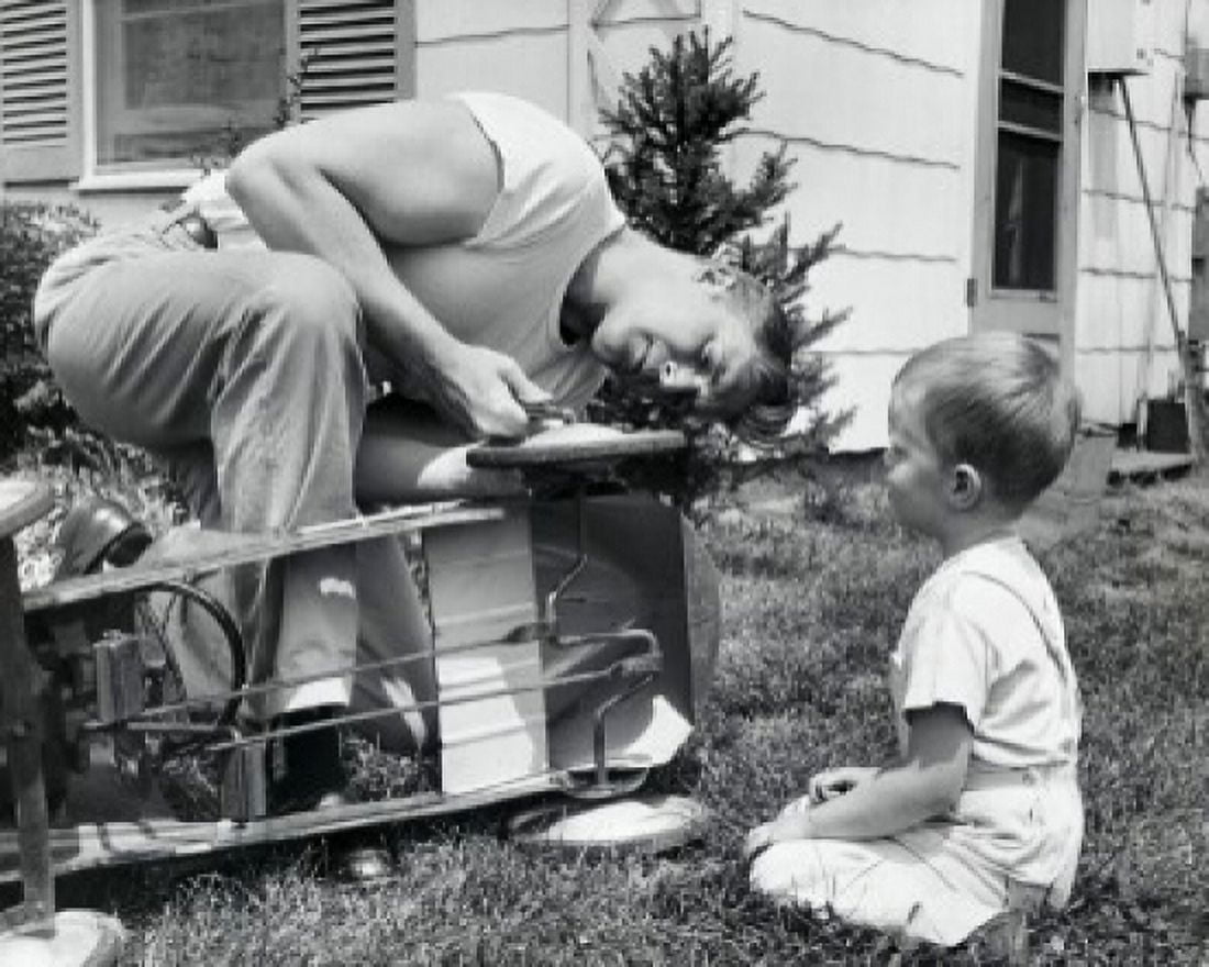 Close-up of a father repairing a toy car with his son sitting in front of him Canvas Art - (24 x 36)