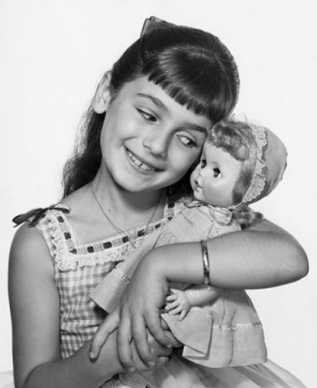 Close-up of a girl hugging a doll and smiling Canvas Art - (18 x 24)