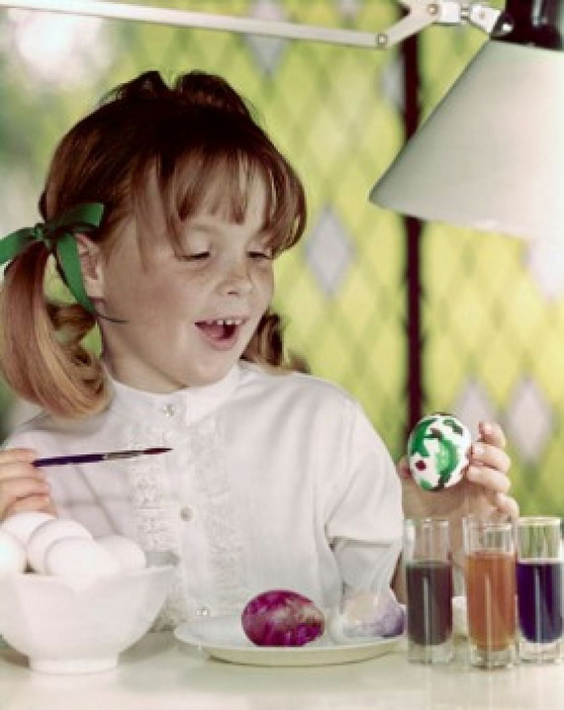 Close-up of a girl painting an Easter egg with a paintbrush Canvas Art - (18 x 24)