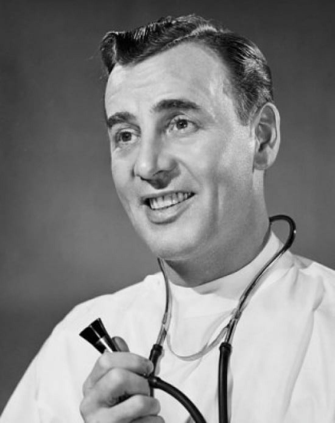 Close-up of a male doctor holding a stethoscope and smiling Canvas Art - (18 x 24)