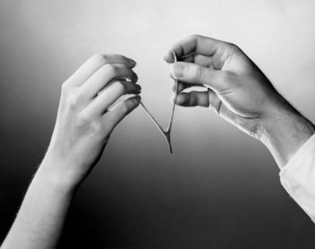 Close-up of a mans and womans hands pulling a wishbone Canvas Art - (24 x 36)